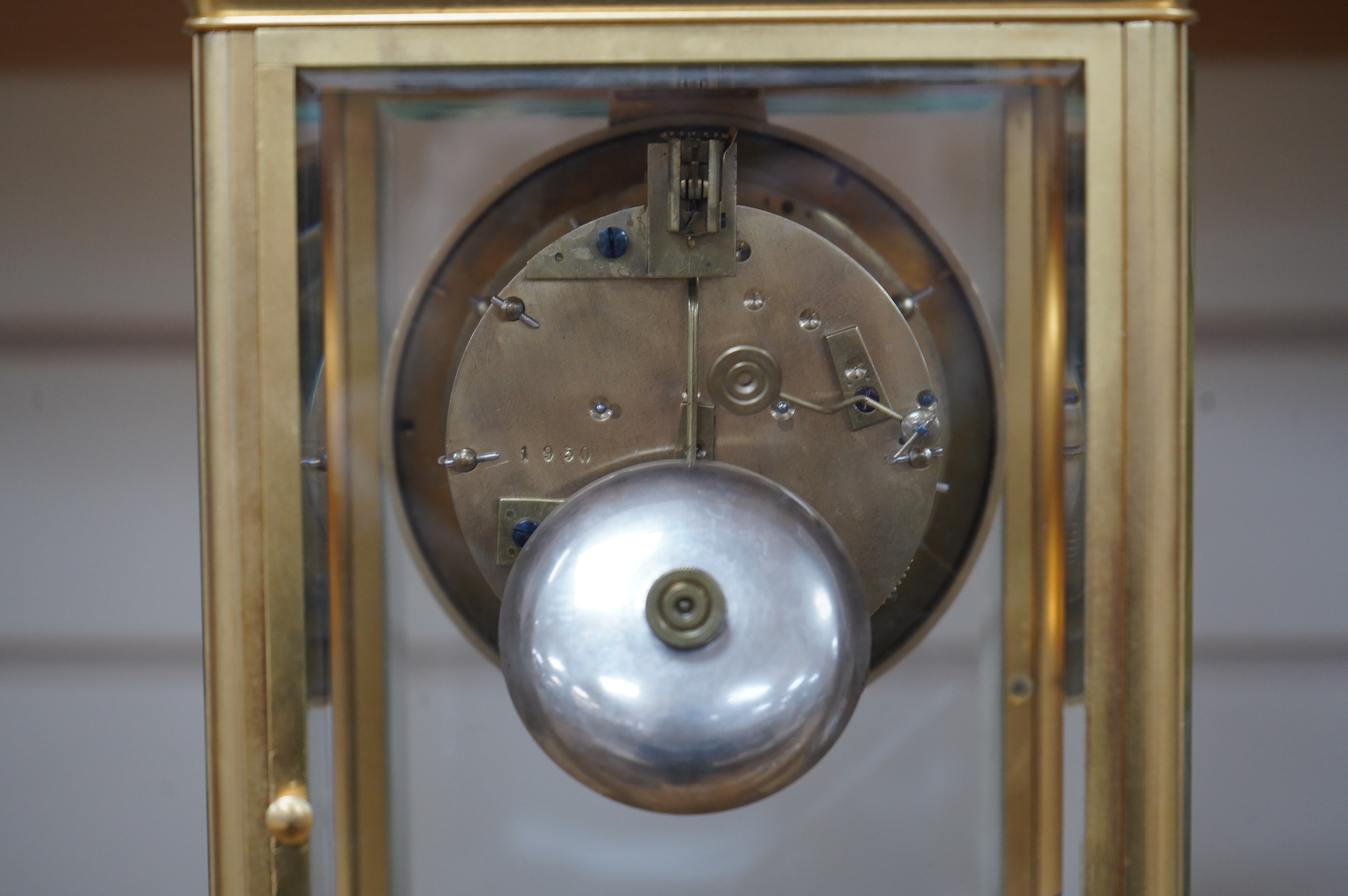 A late 19th century French gilt brass four glass clock, with visible Brocot escapement, key and pendulum, 29.5cm tall. Condition - fair, cracks to dial, not tested